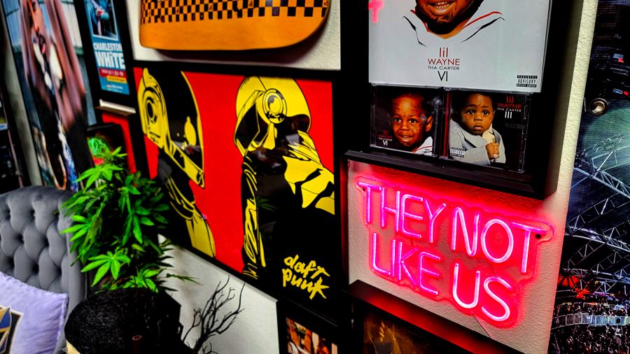 Red neon sign beside framed album art