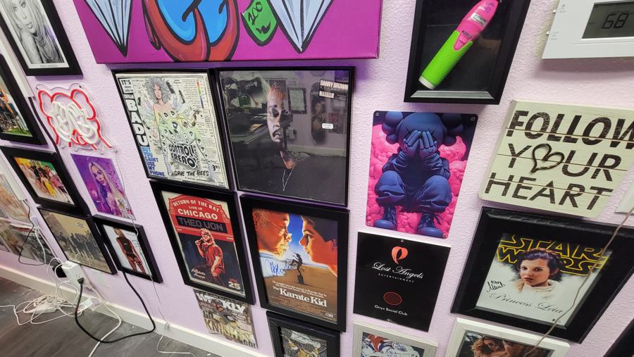 Pink Room wall of framed art and a Follow Your Heart sign