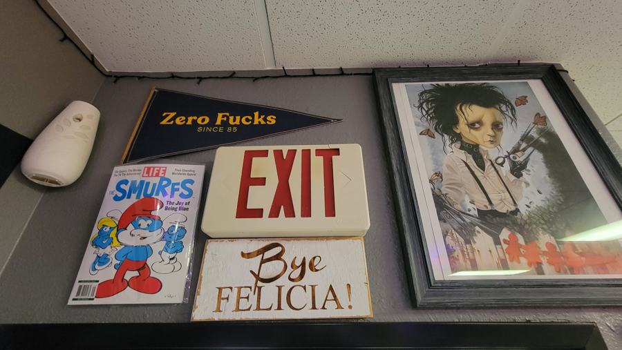 EXIT and Bye Felicia signs with framed art