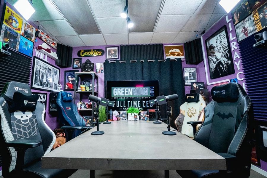 The Green Room: purple walls, framed hip-hop memorabilia and a four-seat podcast table under green neon